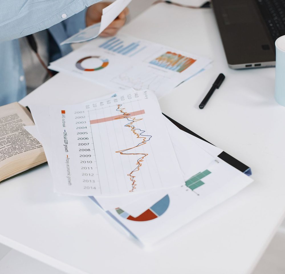 Printed lending reports and charts on a desk during analysis