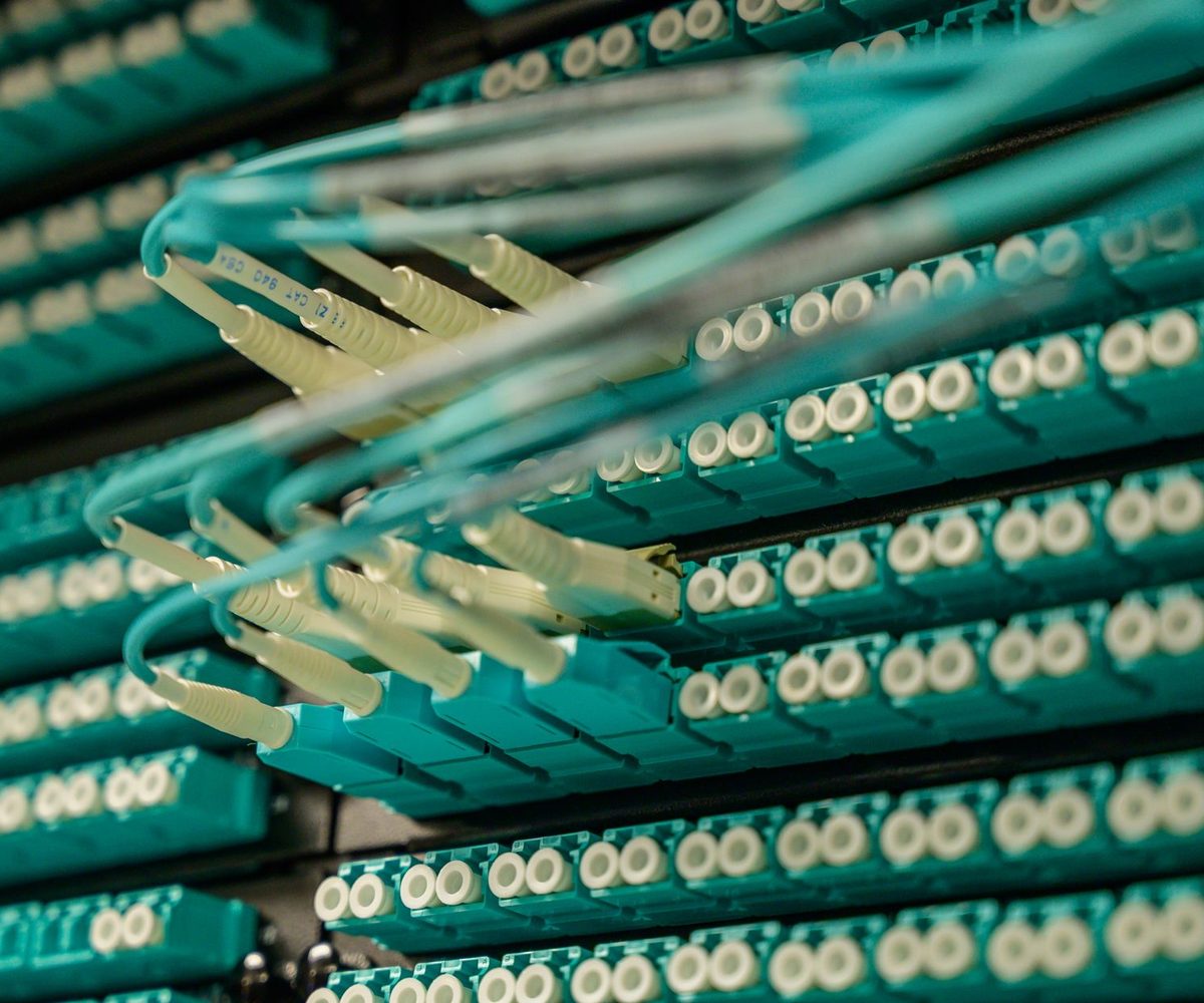 Fibre optic patch cables terminating in a telecoms equipment rack, the infrastructure Form 477 reports on